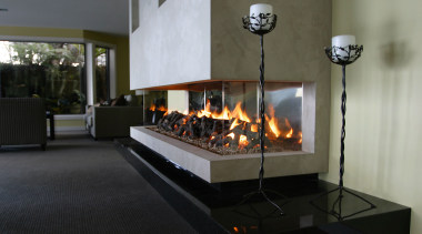 A view of a fireplace from Living Flame. fireplace, hearth, heat, wood burning stove, black, gray