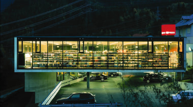 An exterior view of the architecturally design shopping architecture, building, evening, facade, home, house, lighting, night, reflection, residential area, sky, structure, black