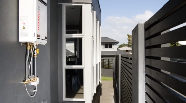 A view of a hot water system by architecture, building, house, property, real estate, black, gray