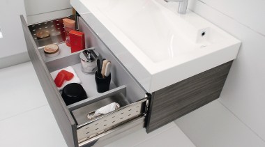 View of this bathroom featuring white cabinetry, stainless bathroom, bathroom accessory, bathroom cabinet, bathroom sink, drawer, furniture, plumbing fixture, product design, sink, white, gray