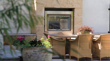 An exterior view of this renovated heritage home flower, furniture, home, outdoor structure, patio, plant, table, window, gray