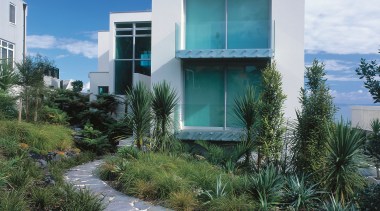 An exterior view of this clifftop house designed architecture, arecales, building, condominium, facade, home, house, real estate, residential area, sky