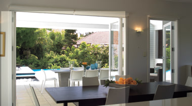 A view of the dining area looking out architecture, daylighting, dining room, door, home, house, interior design, real estate, table, window, window covering, window treatment, gray