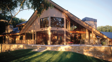 The roof visually archors the home to the cottage, estate, facade, farmhouse, home, house, landscape, lighting, mansion, property, real estate, residential area, roof, siding, black