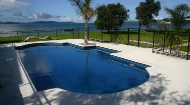 A view of a swimming pool by Cascade. estate, leisure, property, real estate, reflection, resort, sky, swimming pool, tree, vacation, water, blue