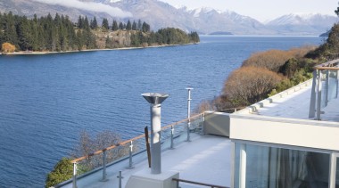 An exterior view of the Club apartments  architecture, glacial landform, home, house, lake, mountain, mountain range, property, real estate, roof, sea, sky, water, waterway, window, teal