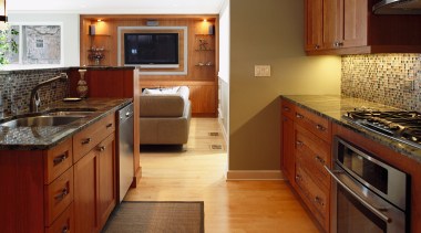 A view of the kitchen and living areas, cabinetry, countertop, cuisine classique, floor, flooring, hardwood, home, interior design, kitchen, real estate, room, wood, wood flooring, brown
