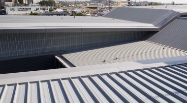 A view of the metal roofing and fibreglass architecture, building, daylighting, daytime, fixed link, line, outdoor structure, roof, sky, structure, water, white, gray