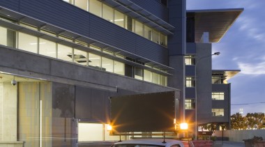 An exterior view of the Greensquare building where automotive design, building, car, compact car, daytime, family car, luxury vehicle, metropolitan area, motor vehicle, sedan, sky, sport utility vehicle, transport, vehicle, black