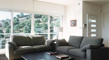 The floor tiles used in this living space angle, ceiling, couch, floor, furniture, home, house, interior design, living room, loveseat, real estate, room, table, window, white, black