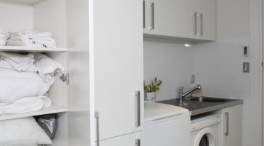Tall cabinetry provides plenty of storage space. The floor, home, home appliance, interior design, kitchen, laundry, laundry room, major appliance, room, gray