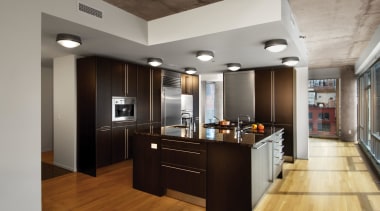 A view of an apartment complex developed by cabinetry, ceiling, countertop, floor, flooring, hardwood, interior design, kitchen, laminate flooring, wood flooring, gray