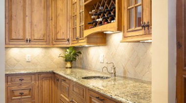 A view of this kitchen featuring Plato Woodwork cabinetry, countertop, cuisine classique, flooring, furniture, hardwood, home, interior design, kitchen, room, under cabinet lighting, wall, wood stain, brown, orange