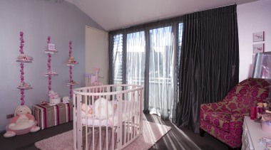 This bedroom, dsigned by Allium, is centred round bed, bedding, bedroom, ceiling, curtain, home, interior design, nursery, pink, product, real estate, room, textile, window, window covering, window treatment, gray