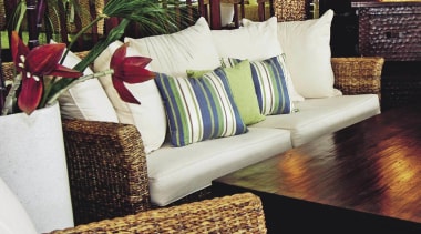 A view of this Samarang furniture that features chair, couch, cushion, flooring, furniture, home, interior design, living room, table, wicker, wood, white