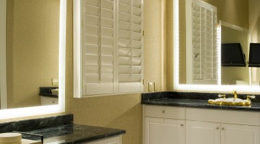 A view of the interior living areas featuring bathroom, bathroom accessory, bathroom cabinet, cabinetry, countertop, cuisine classique, floor, flooring, home, interior design, kitchen, room, sink, window, brown