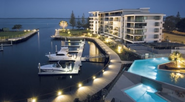 An exterior view of the New Stocland Allisse condominium, dock, hotel, luxury yacht, marina, mixed use, passenger ship, property, real estate, resort, yacht, blue