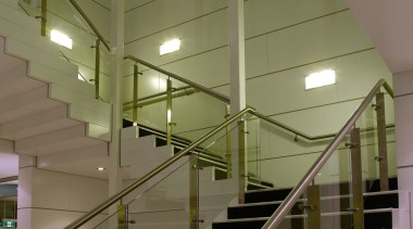 A view of this feature stair case where architecture, ceiling, daylighting, glass, handrail, interior design, stairs, structure, brown