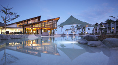 The main pool and beach resturant at Radisson architecture, estate, evening, home, hotel, leisure, mixed use, real estate, reflection, resort, resort town, sky, swimming pool, water, teal, blue