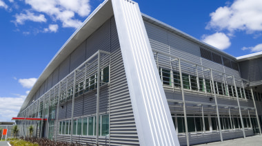 Stuated on landscape grounds, Highbrook business park consists architecture, building, commercial building, corporate headquarters, daytime, facade, headquarters, mixed use, real estate, sky, structure, gray
