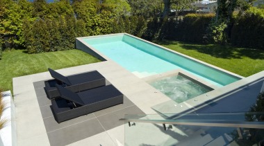 A view of a swimming pool by Mayfair backyard, daylighting, leisure, outdoor furniture, property, roof, sunlounger, swimming pool, water