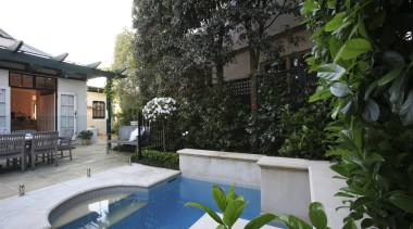 An exterior view of the pool and patio backyard, courtyard, estate, home, house, outdoor structure, plant, property, real estate, resort, tree, villa, yard, green