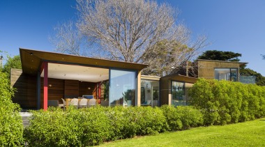 An exterior view of the home, windows and architecture, cottage, estate, facade, farmhouse, grass, home, house, landscape, lawn, plant, property, real estate, residential area, roof, siding, sky, suburb, tree, villa, yard
