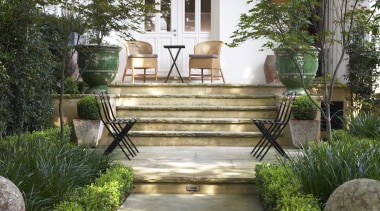 With paving and planting, the front garden of backyard, courtyard, estate, flower, garden, home, house, landscaping, outdoor structure, porch, real estate, walkway, yard, brown, gray