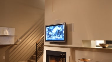 view of kitchen and living area, featuring cabinetry, ceiling, fireplace, floor, hearth, home, interior design, living room, brown