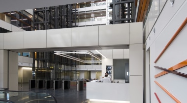 interior view of building featuring escalators, lighting, doors architecture, building, glass, institution, interior design, lobby, stairs, gray