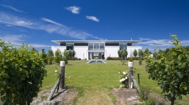 An exterior view of the entire home, vineyard. cloud, cottage, estate, facade, farmhouse, home, house, land lot, plantation, property, real estate, residential area, sky, tree, villa, blue