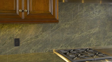 View of a stone countertop by A Touch cabinetry, countertop, floor, flooring, hardwood, interior design, kitchen, room, tile, under cabinet lighting, wall, wood, wood flooring, wood stain, brown