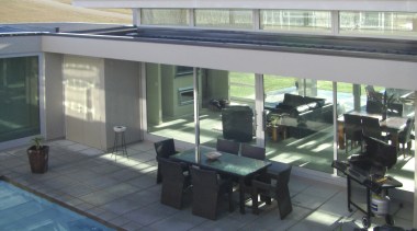 A view of a home designed by Gary glass, real estate, roof, gray