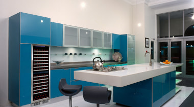 Open-plan winery kitchen with blue glass cupboards, long countertop, interior design, kitchen, product, product design, white, gray
