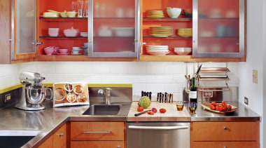 view of kitchen cabinetry, lightng, wooden flooring, sink, cabinetry, countertop, interior design, kitchen, orange, room, shelf, red