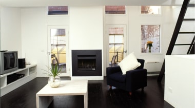 View of a lounge area, with dark flooring, furniture, interior design, living room, room, white, black, gray