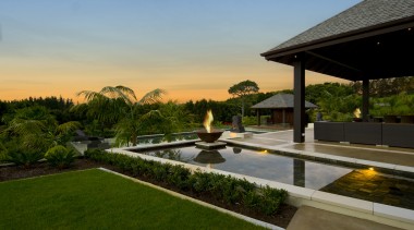 Exterior view of resort-style home designed by Masonry backyard, estate, grass, home, house, landscape, landscaping, lighting, property, real estate, reflecting pool, resort, swimming pool, villa, brown