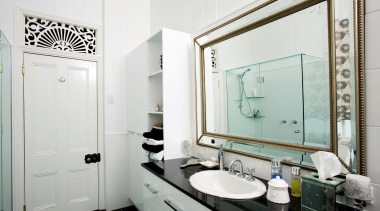A granite-topped vanity provides generous storage, while mirrors bathroom, home, interior design, room, white, gray