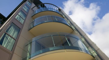 Curved glass balustrades help to maximise views from architecture, building, commercial building, daylighting, daytime, facade, glass, sky, structure, teal