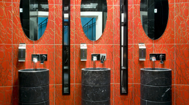 A decorative motif features throughout the interior. The interior design, orange, public toilet, red, room, wall, red