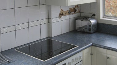 Image of renovated kitchen featuring lighting, kitchen appliances, cabinetry, countertop, cuisine classique, floor, flooring, home, home appliance, kitchen, kitchen appliance, kitchen stove, major appliance, room, sink, tile, gray