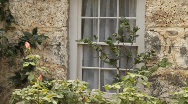 Exterior view of a window in this colonial-styled facade, flower, home, house, plant, tree, window, brown, orange