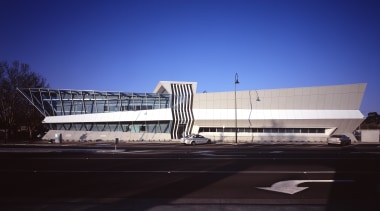 Security, sustainability, and sheer street presence are all architecture, building, convention center, corporate headquarters, daylighting, daytime, facade, fixed link, headquarters, infrastructure, landmark, metropolitan area, sky, sport venue, stadium, structure, blue, black