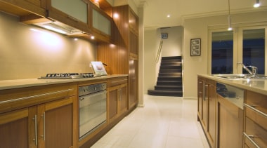 Timber cabinetry brings visual warmth to the open-plan cabinetry, countertop, cuisine classique, home, interior design, kitchen, real estate, room, wood, brown, orange