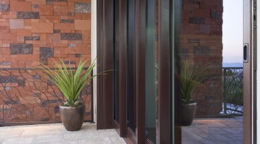 The sliding pocket doors in the great room, architecture, brick, door, floor, flooring, hardwood, home, interior design, laminate flooring, real estate, tile, wall, window, wood, wood flooring, wood stain, gray, black