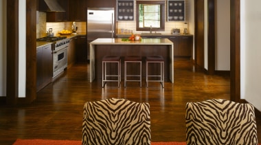 The color scheme of golds and browns gives floor, flooring, hardwood, interior design, kitchen, laminate flooring, living room, room, wood, wood flooring, brown