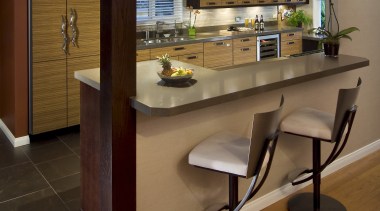 Floors are laid with dark porcelain tiles in cabinetry, countertop, floor, flooring, furniture, interior design, kitchen, table, brown