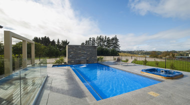 This new L-shaped pool, designed and built by estate, home, house, leisure, property, real estate, residential area, sky, swimming pool, villa, water, gray, teal