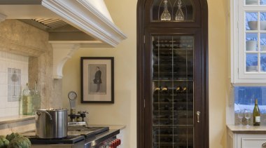 It is the fine millwork and attention to cabinetry, ceiling, countertop, cuisine classique, floor, hardwood, home, interior design, kitchen, room, window, wood flooring, brown, gray, orange