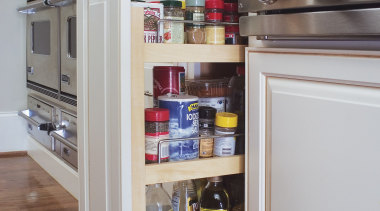 Soft white cabinets are paired with a cherry cabinetry, kitchen, refrigerator, shelf, shelving, gray